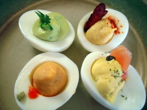 From top left: avocado, traditional, smoked salmon, and wasabi-Srirach deviled eggs.